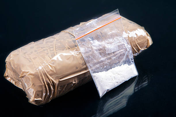 Cocaine powder in plastic bag with a packages